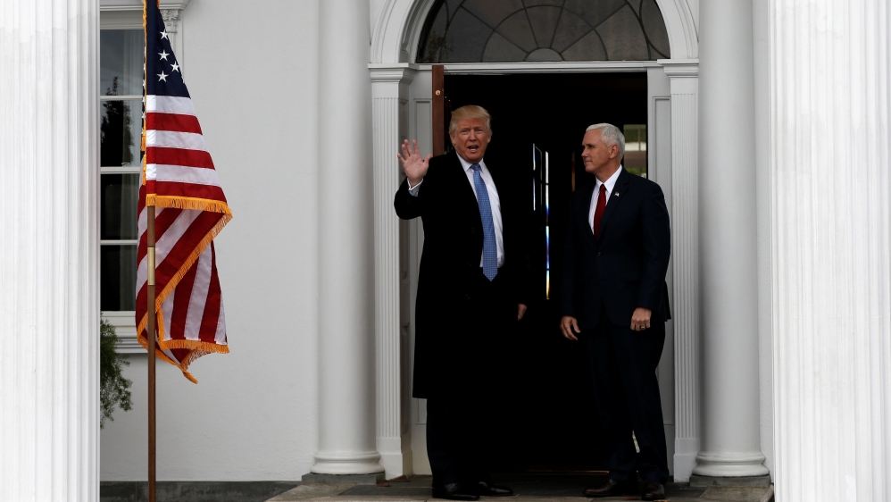 U.S. President-elect Donald Trump and Vice President-elect Mike Pence stand at the entrance to the main clubhouse at Trump National Golf Club in Bedminster