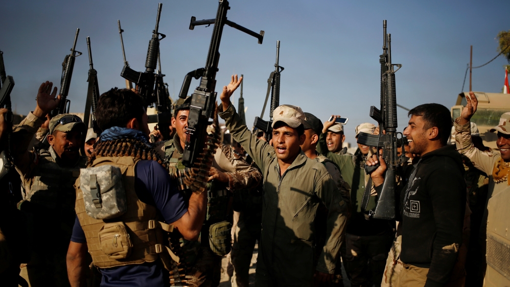 Iraqi soldiers dance as they celebrate during a fighting with Islamic State fighters, at the front line in the Shahrazad district of eastern Mosul
