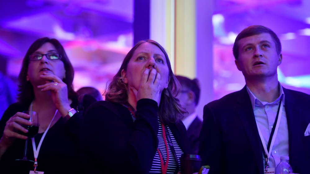 People react to the television coverage of U.S. presidential election results during an election party at the U.S. embassy in London
