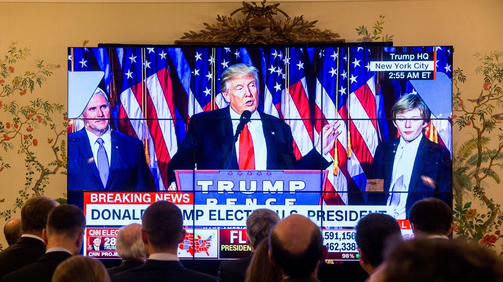 People watch Donald Trump deliver his speech after winning the US election [Stephanie Lecocq/EPA]