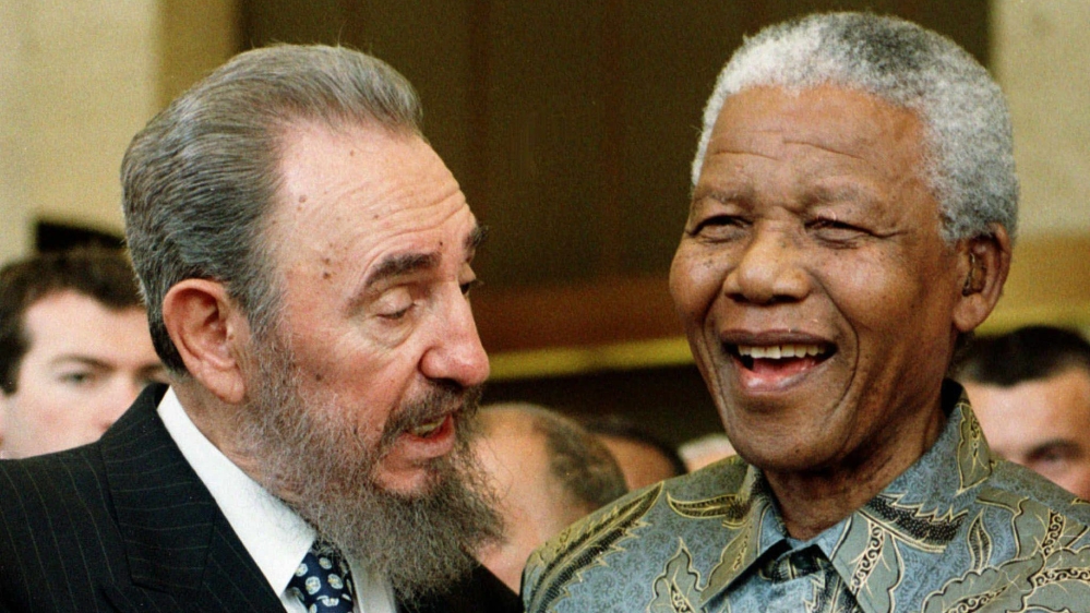 Castro speaking to Mandela at the 50th anniversary of the GATT Agreement [Patrick Aviolat/ EPA] 