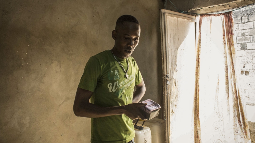 Herve Kinfumu, 25, is an art student who draws tattoos but doesn't have any of his own [Francesca Volpi/Al Jazeera]