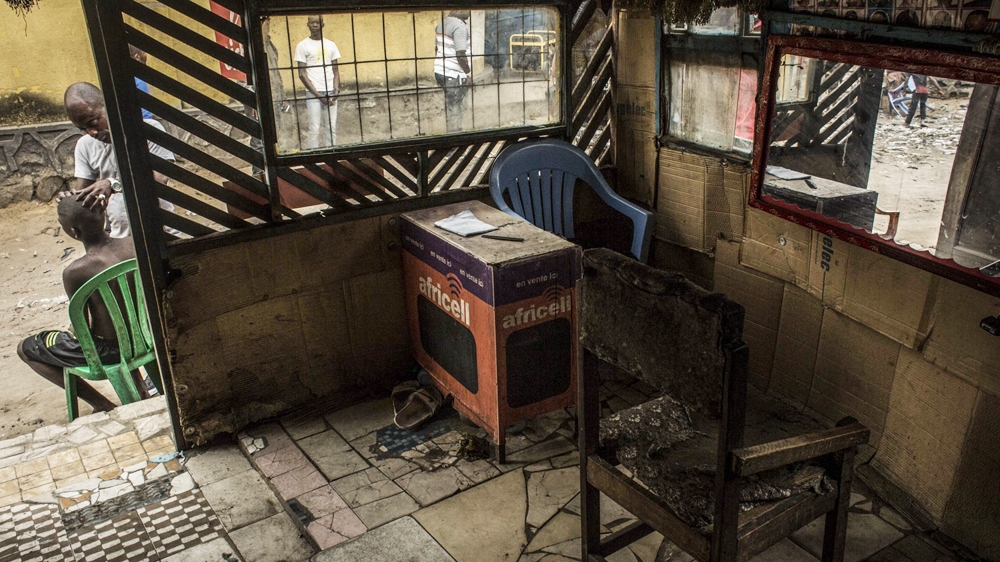 Kris Bitenda, a barber and tattoo artist, owns this barbershop in the Lubugi district, in Kinshasa [Francesca Volpi/Al Jazeera]
