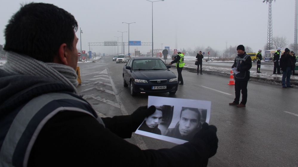 A Turkish police holds pictures of the suspected gunman