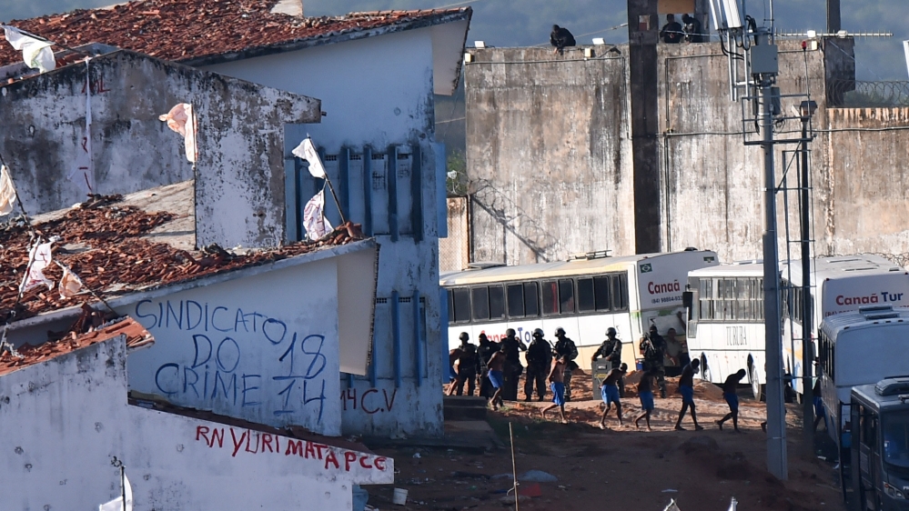 Inmates line up near riot police at Alcacuz prison in Natal