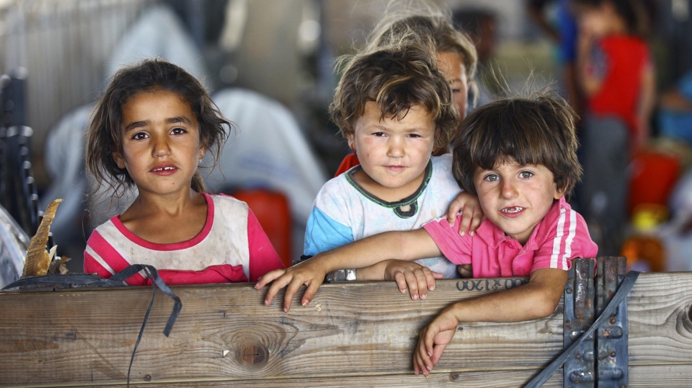 Iraqi Shiite Turkmen children fleeing the violence in the Iraqi city of Tal Afar, arrive at a refugee camp on the outskirts of Arbil