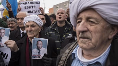 Kosovar Albanians hold photographs of Ramush Haradinaj as they gather to demand the release of Kosovo's former prime minister, in Pristina, Kosovo [Valdrin Xhemaj//EPA]