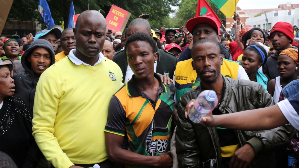 Victor Mlotshwa, centre, says he wants justice [Siphiwe Sibeko/Reuters]