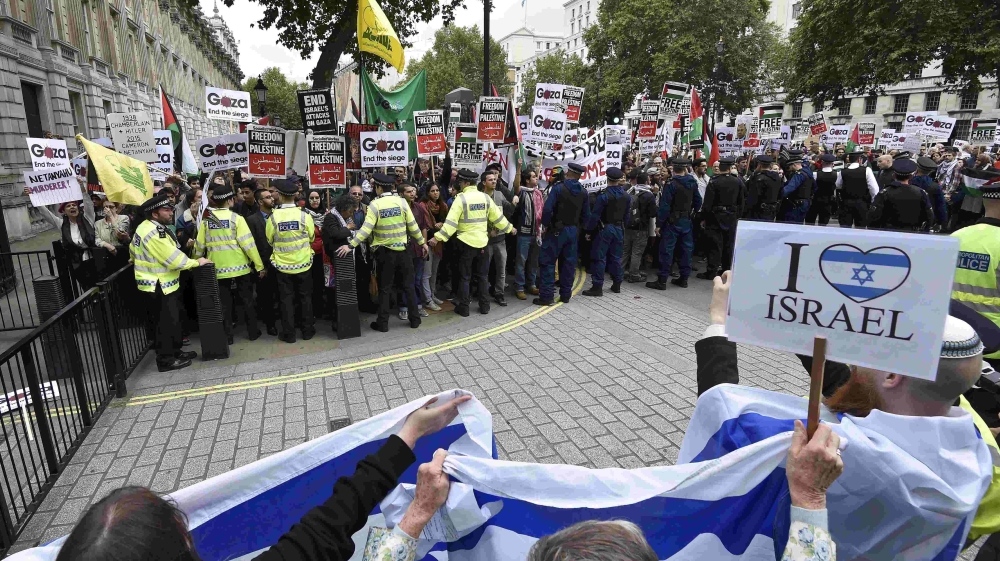 Demonstrators protest outside Downing Street in London