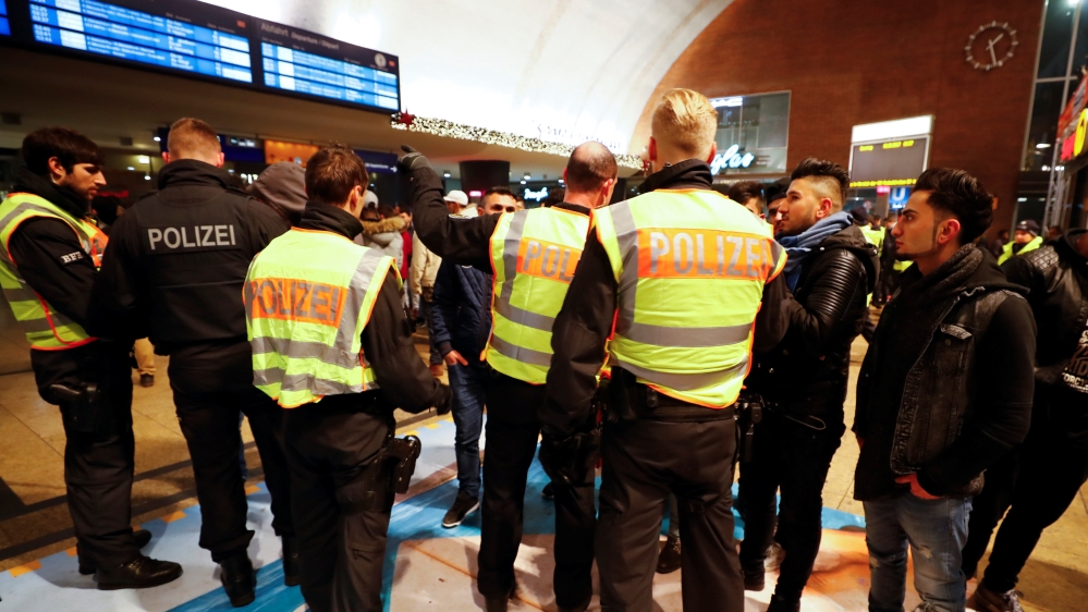 Police officers of Germany''s federal police Bundespolizei check young men at Cologne''s main railways station following New Year celebrations