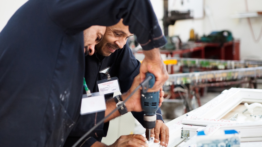 Two victims of war practise carpentry at the rehabilitation centre [Arianna Pagani/Al Jazeera] 