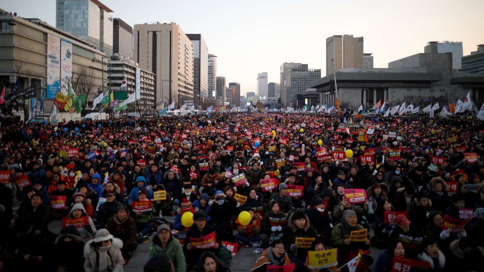 People attend a protest demanding South Korean President Park Geun-hye''s resignation on the occasion of the fourth anniversary of her inauguration, in Seoul