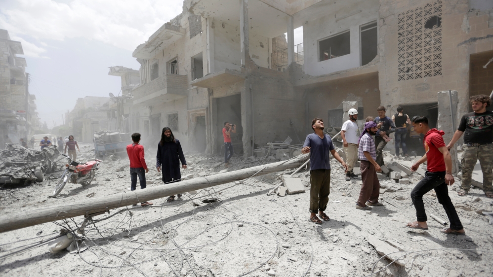 People inspect the damage at a site hit by airstrikes in the rebel-controlled area of Maaret al-Numan town in Idlib on June 2, 2016 [Reuters]