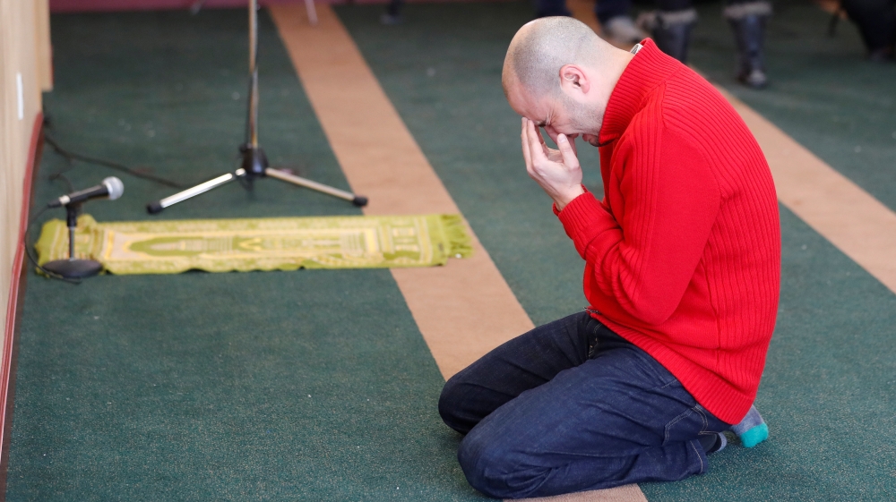 A man cries while he prays at the Quebec Islamic Cultural Centre in Quebec City