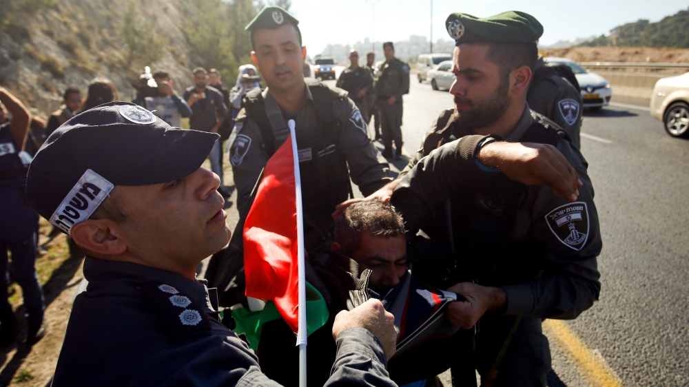 detain a Palestinian protester during a protest against a promise by U.S. President-elect Donald Trump to re-locate U.S. embassy to Jerusalem, in the West Bank near Jewish settlement of Maale Adumim