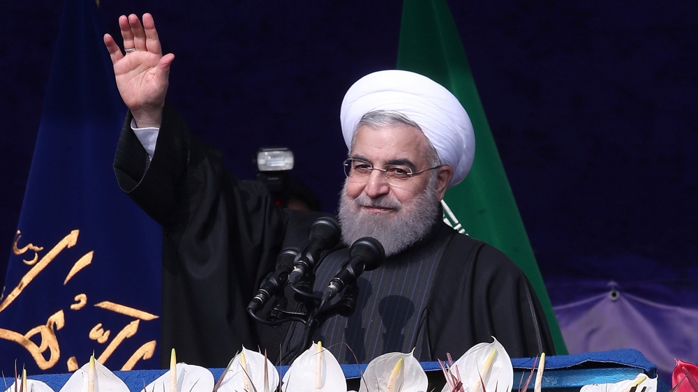 Iran''s President Hassan Rouhani waves during a ceremony marking the anniversary of Iran''s 1979 Islamic Revolution, in Tehran