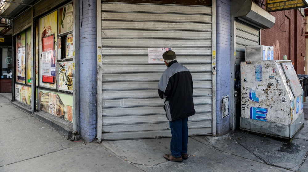 A man reads a sign announcing the closure of a bodega during a Yemeni protest against President Donald Trump''s travel ban, in the Brooklyn borough of New York City