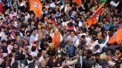 Supporters welcome BJP President, Amit Shah, centre, as he makes a victory sign as he arrives at party headquarters in New Delhi, India on March 11 [EPA]