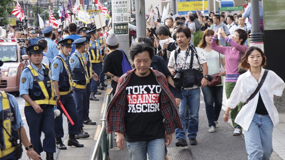 Noma Yasumichi (centre), founder of TwitNoNukes and the Counter-Racist Action Collective. Photograph from September 23, 2014, in Roppongi, Tokyo [Courtesy of Natsuki Kimura]