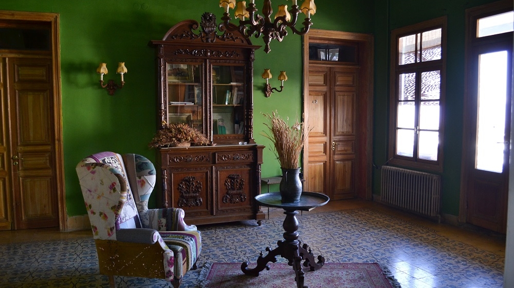 Palmyra Hotel's owners strive to preserve the hotel with its creaking beds, gurgling pipes and ancient furnishings [India Stoughton/Al Jazeera]