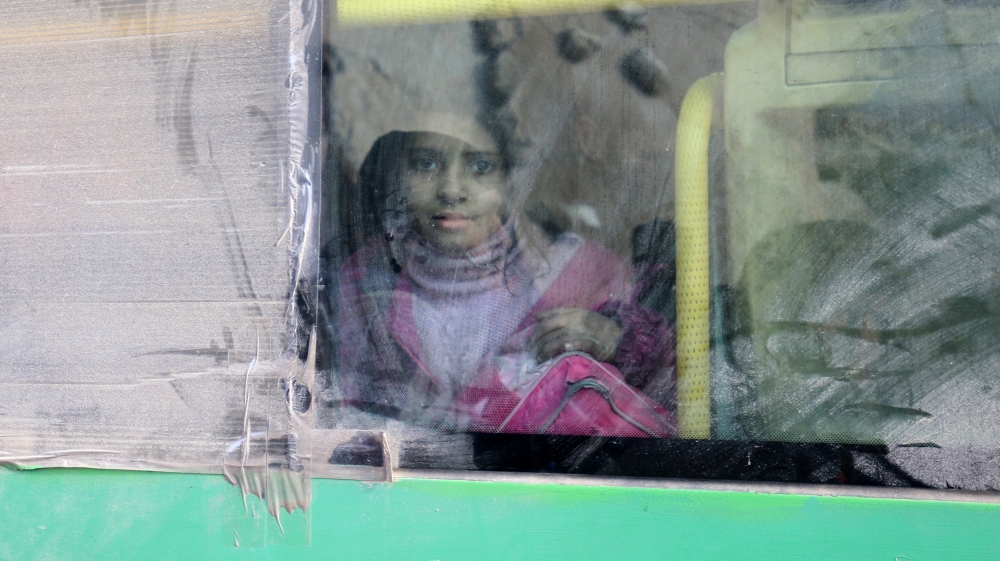 A girl rides a bus to be evacuated from a rebel-held sector of eastern Aleppo