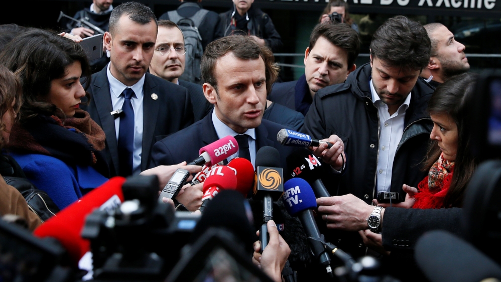 Emmanuel Macron, head of the political movement En Marche !, or Onwards !, and candidate for the 2017 presidential election, speaks with journalists as he leaves a police station in Paris