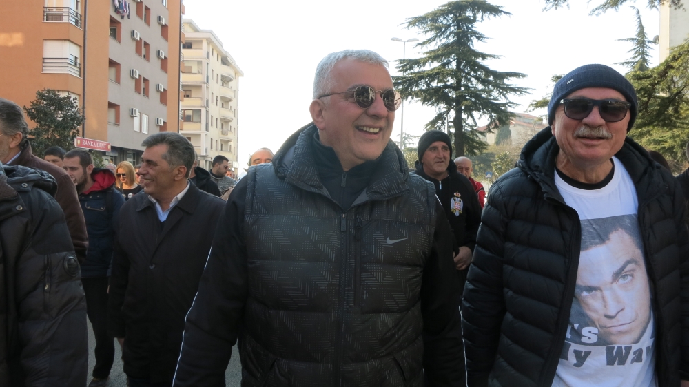 Parliament voted to strip opposition leader Andreja Mandic of immunity from prosecution, citing alleged involvement in the coup. But when Mandic arrived at the building to await his arrest, he was joined by a large crowd of supporters [Al Jazeera]