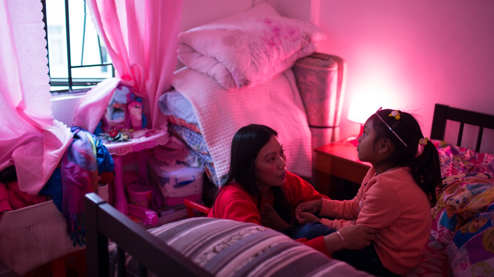 Five-year-old Keana listens to Rodel's reassurance that she is loved and things will get better [Maria de la Guardia/Al Jazeera]