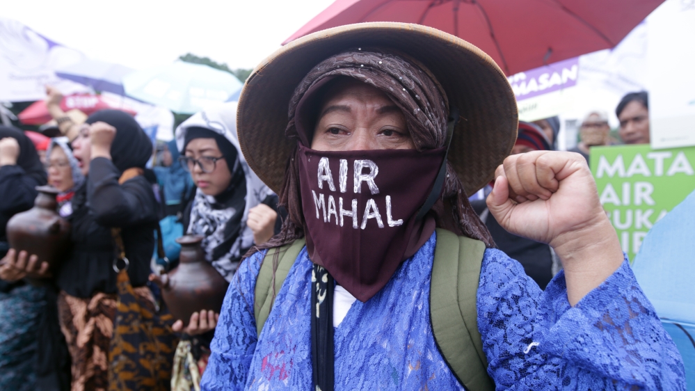 Women say cement factories built in Karst Mountains will ruin their land [Bagus Indahono/EPA]