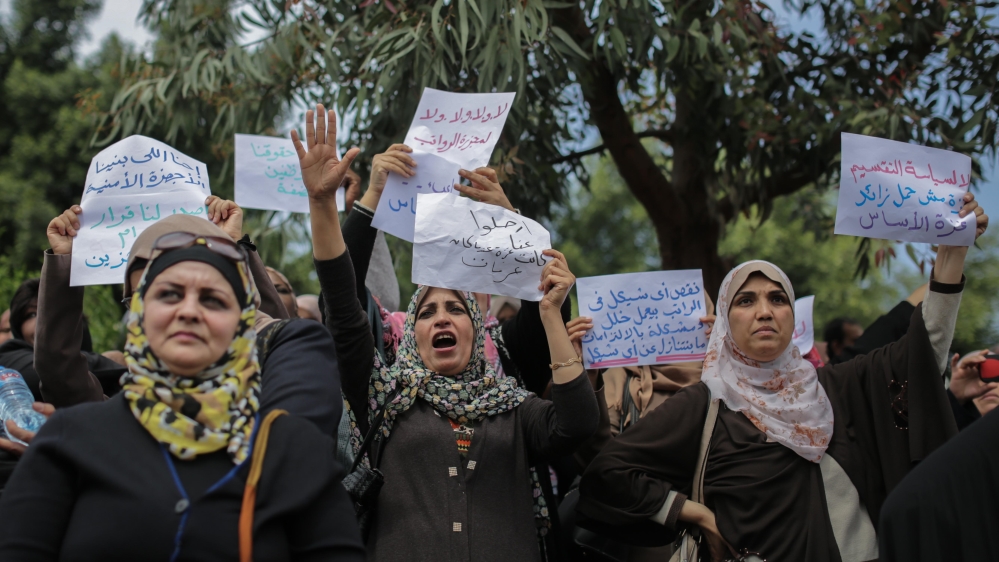 During protests against pay cuts in Gaza. One sign reads 