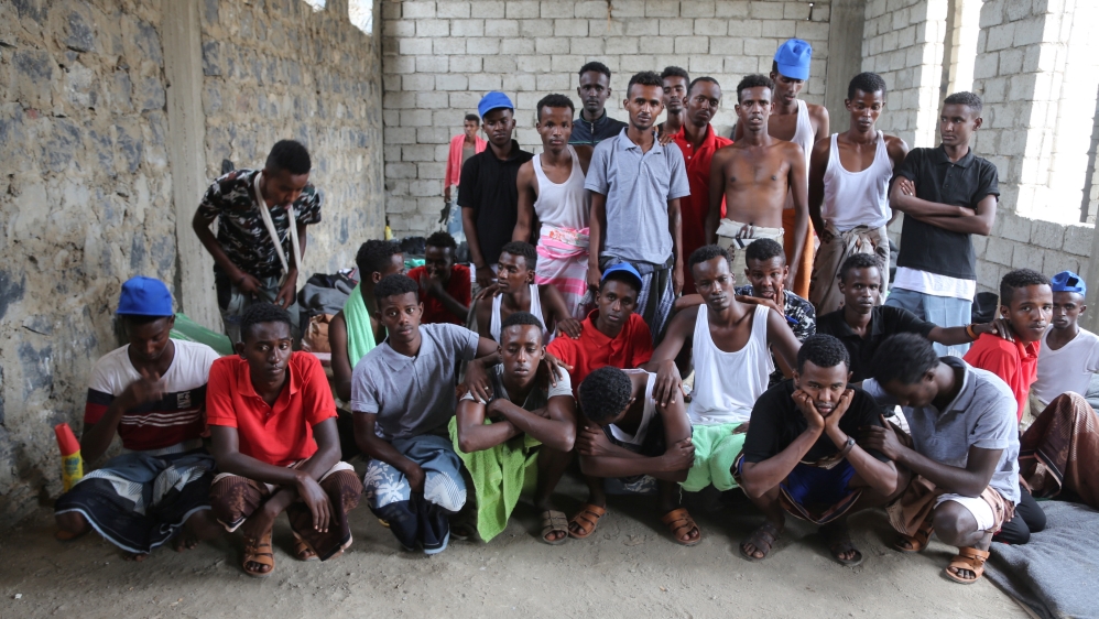 Somali refugees who survived an attack on a boat off Yemen''s coast in the Red Sea pose for a group photo as they wait at a detention center in the Houthi-held port of Hodeidah, Yemen