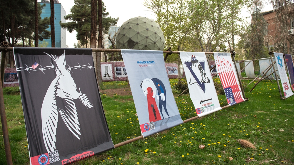 The lawn outside the embassy is packed with anti-US and anti-Israel political statements [Wojtek Arciszewski/Al Jazeera]