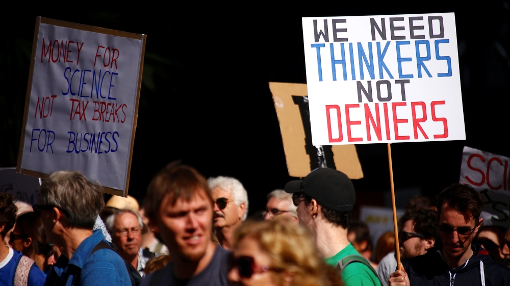 Protesters hold placards and banners as they participate in the March for Science rally on Earth Day, in central Sydney