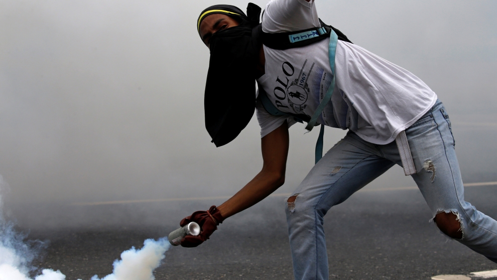 Opposition supporters clash with riot police on Thursday [Carlos Garcia Rawlins/Reuters]