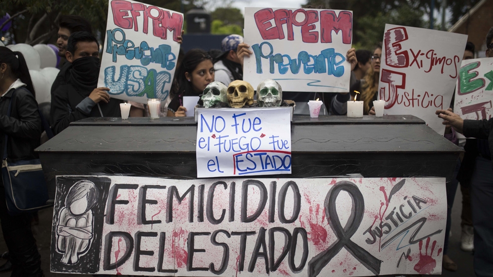 
On March 15, at the University of San Carlos de Guatemala, protesters display a mock coffin covered with skulls and signs which in Spanish read: 