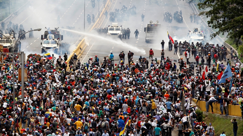 More than 30 people have been killed since the anti-Maduro unrest began in early April [Christian Veron/Reuters]