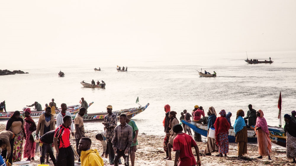 Early morning at the fishing wharf of Thiaroye-sur-mer [Max Hirzel/Al Jazeera]