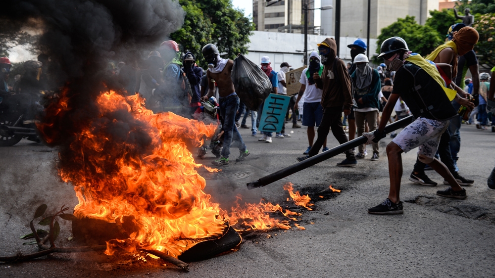 Protesters threw rocks and molotov cocktails at riot police [Federico Parra/AFP]
