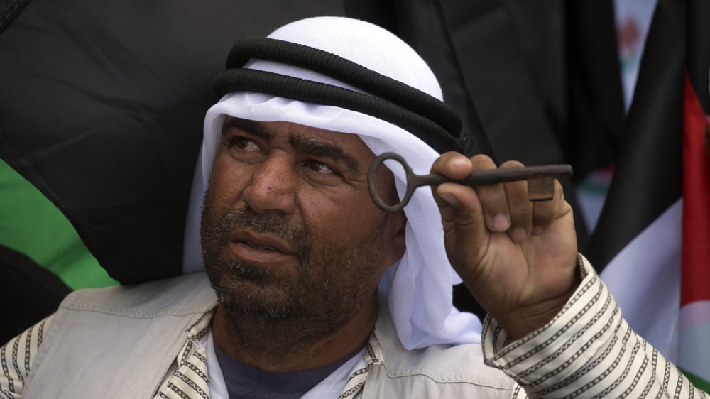 A Palestinian protester holds a key during a rally marking the 69th anniversary “Nakba” in Nablus