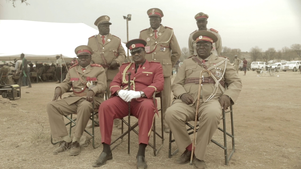 Advocate Vekuii Rukoro (front, dressed in red), the paramount chief of the Herero people, at a heroes' commemoration service in Okeseta, west of Windhoek [Screengrab/Al Jazeera] 