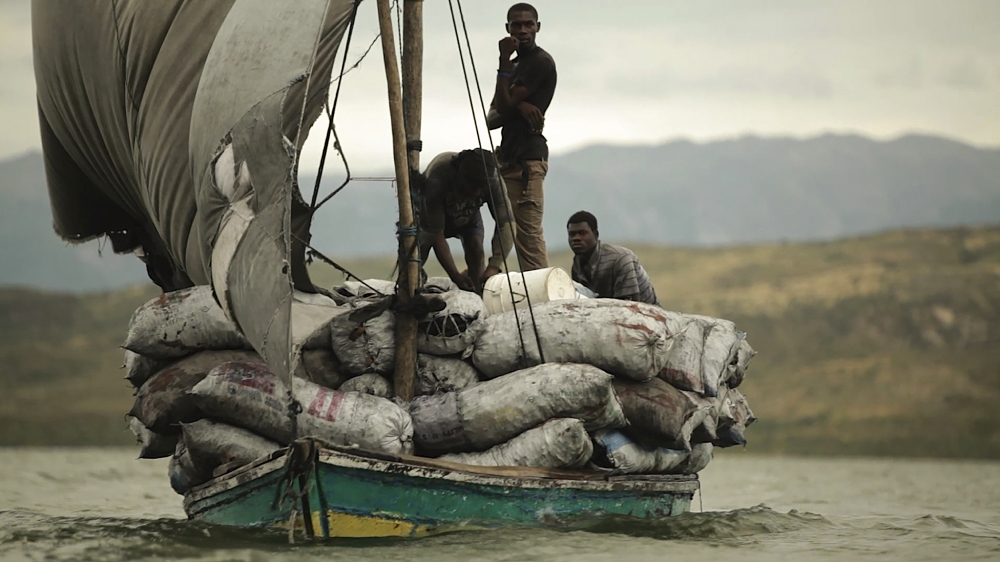 Charcoal produced in the Dominican Republic illegally crosses the border to Haiti by simple sailboats [Juan Carlos Castaneda]