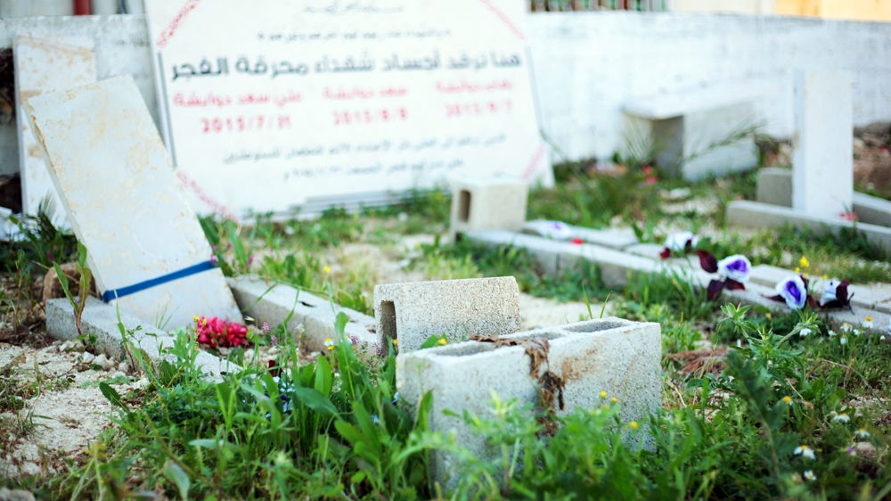 The breeze-block grave of 18-month-old Ali Dawabsheh is seen next to those of his parents [Leila Molana-Allen/Al Jazeera]