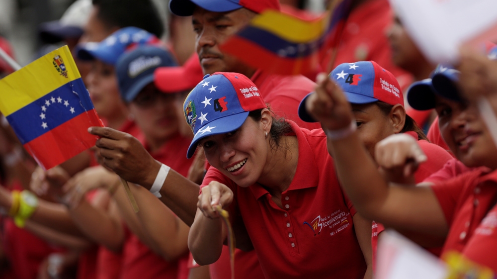 Pro-Maduro demonstrators staged a rival march in support of plan for a new constitution [Marco Bello/ Reuters]