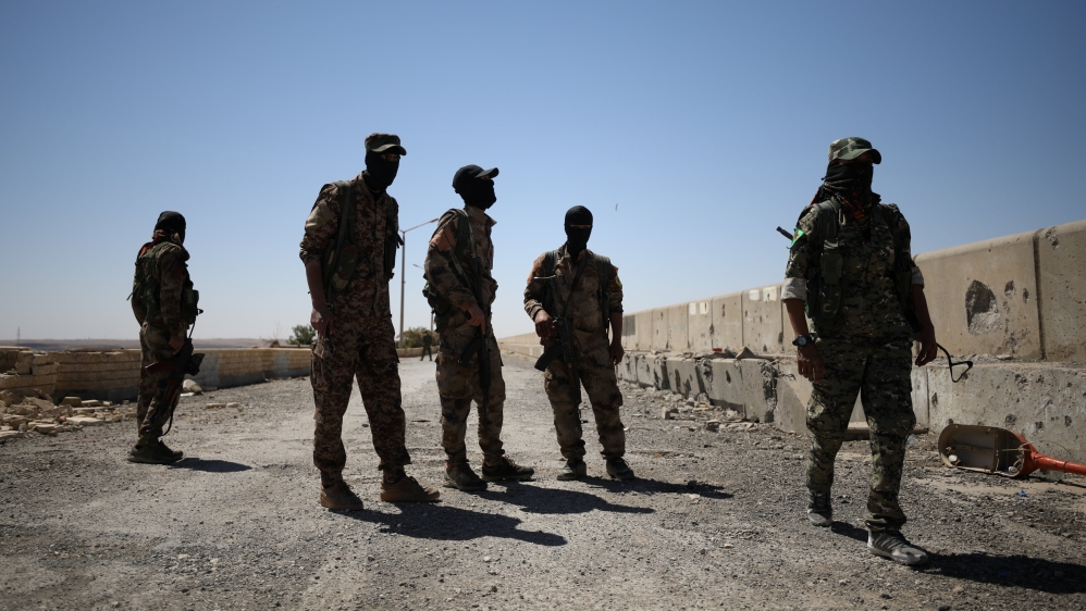 Syrian Democratic Forces (SDF) fighters stand in the town of Tabqa, after capturing it from Islamic State militants this week