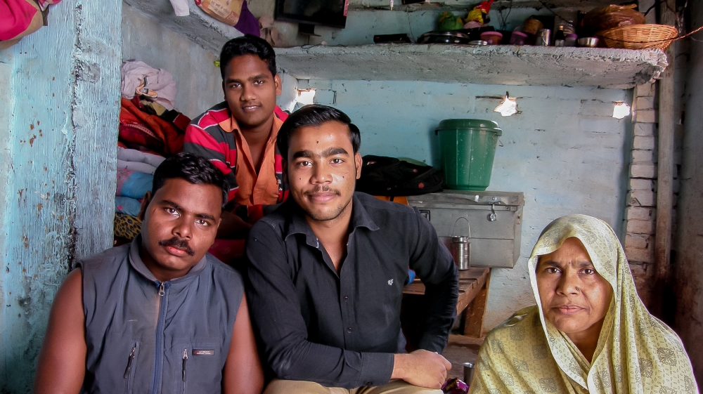 Mithun, left, Ansh, Yogi and Yogi's mother Pushpa Devi sit in Yogi's family home. [Radhika Iyengar/Al Jazeera]