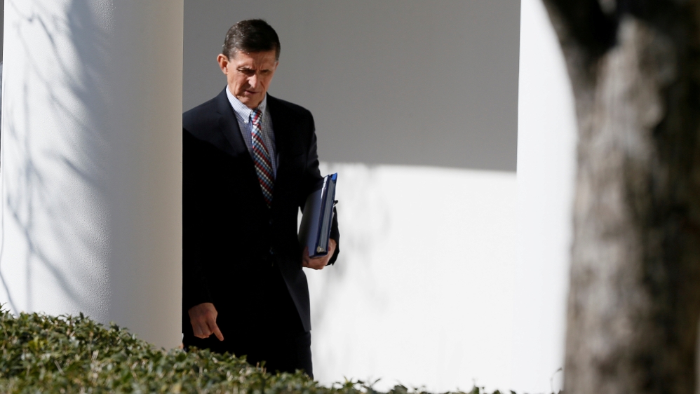 FILE PHOTO - White House National Security Advisor Flynn walks down the White House colonnade on the way to Abe and Trump joint news conference at the White House in Washington