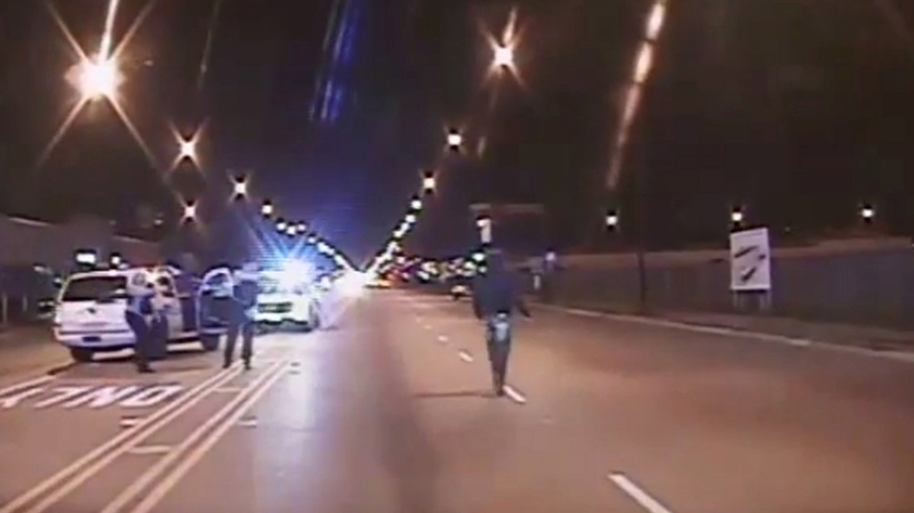 Laquan McDonald, right, walks on a road before he was shot 16 times by police officer Jason Van Dyke in Chicago, in this still image taken from a police vehicle dash camera video [File: Handout/Chicago Police Department/Reuters]