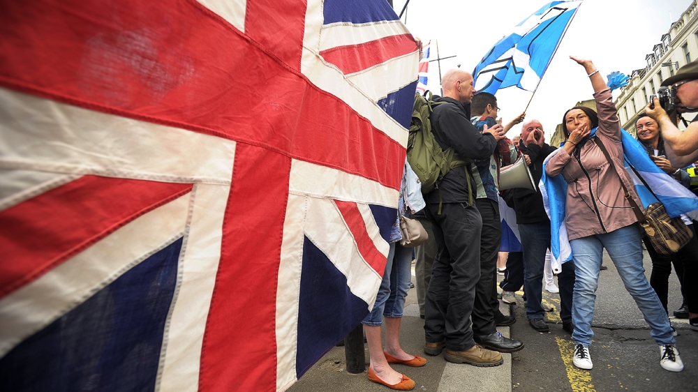 Scotland: Pro-Union supporters hold up a Union flag in reaction to a pro-Independence march through Glasgow