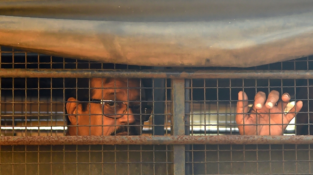 Indian convicted for his role in the 1993 Mumbai bomb blasts sits inside a police van
