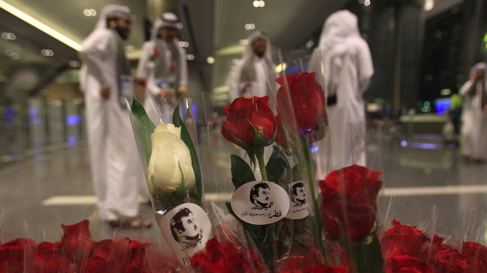Flowers and pictures of Qatar Emir Sheikh Tamim Bin Hamad Al-Thani are pictured during the arrival of Kuwaiti and Omani citizen at Hamad international airport in Doha